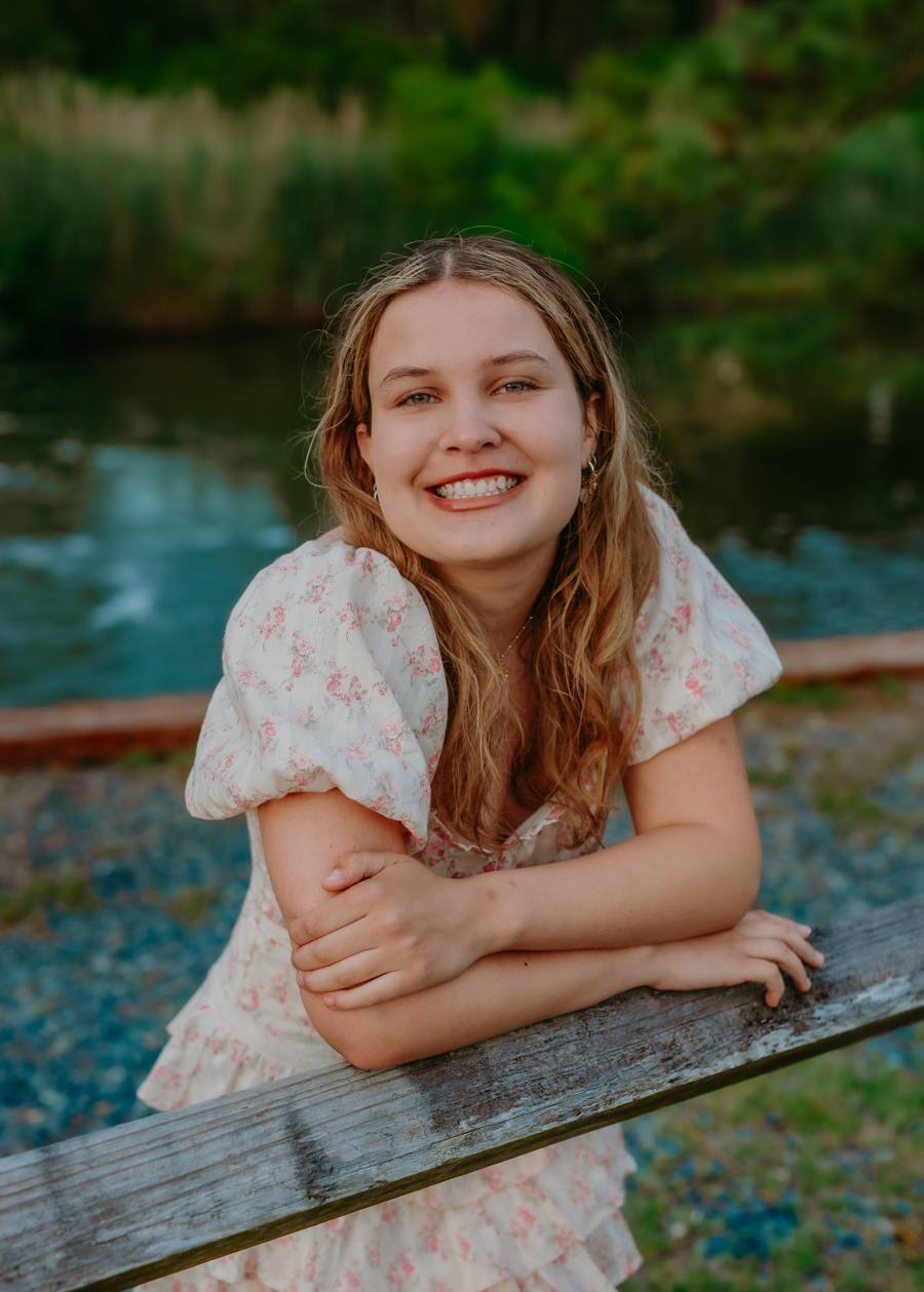 Brooke Shupp, founder of Pages of Purple, smiling outdoors.